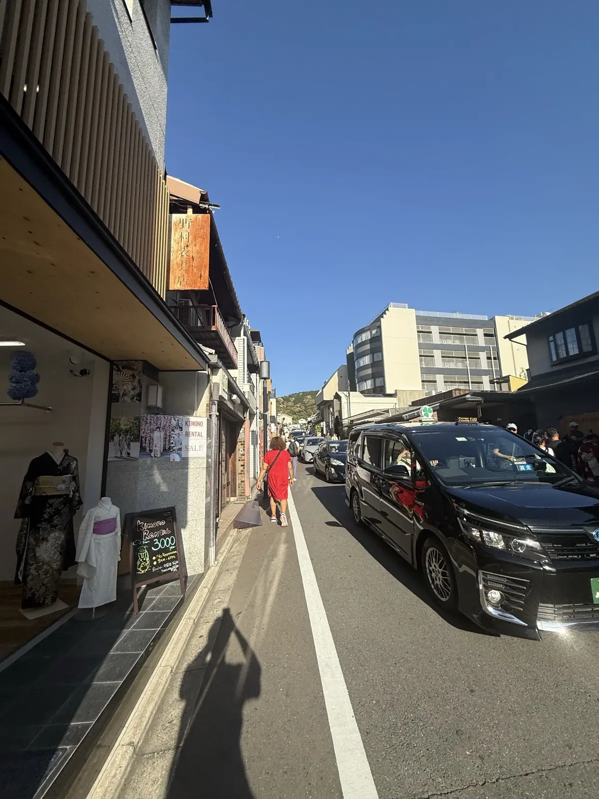 The shop-lined uphill slope approaching Kiyomizu-dera, with kimono-rental shops and souvenir stores — our own photo