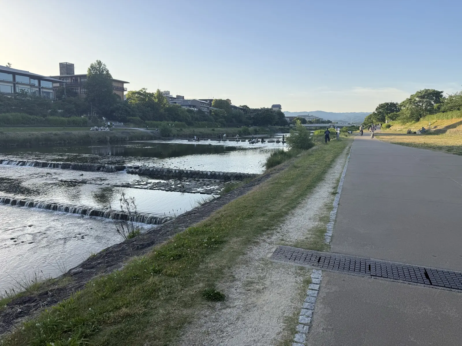 The grassy banks and riverside path of the Kamo river in Kyoto — our own photo