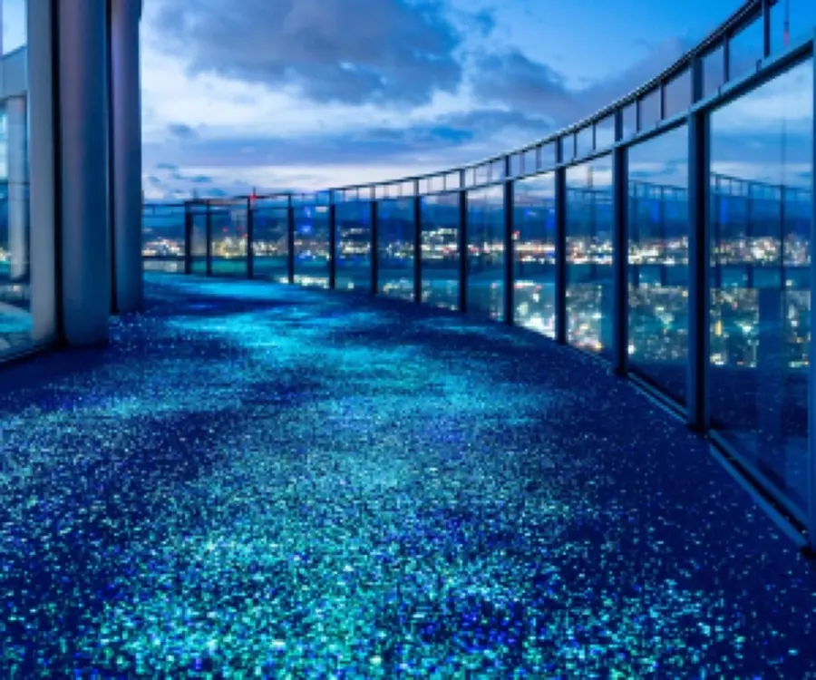 The glowing Lumi Sky Walk floor on the rooftop of the Umeda Sky Building at dusk