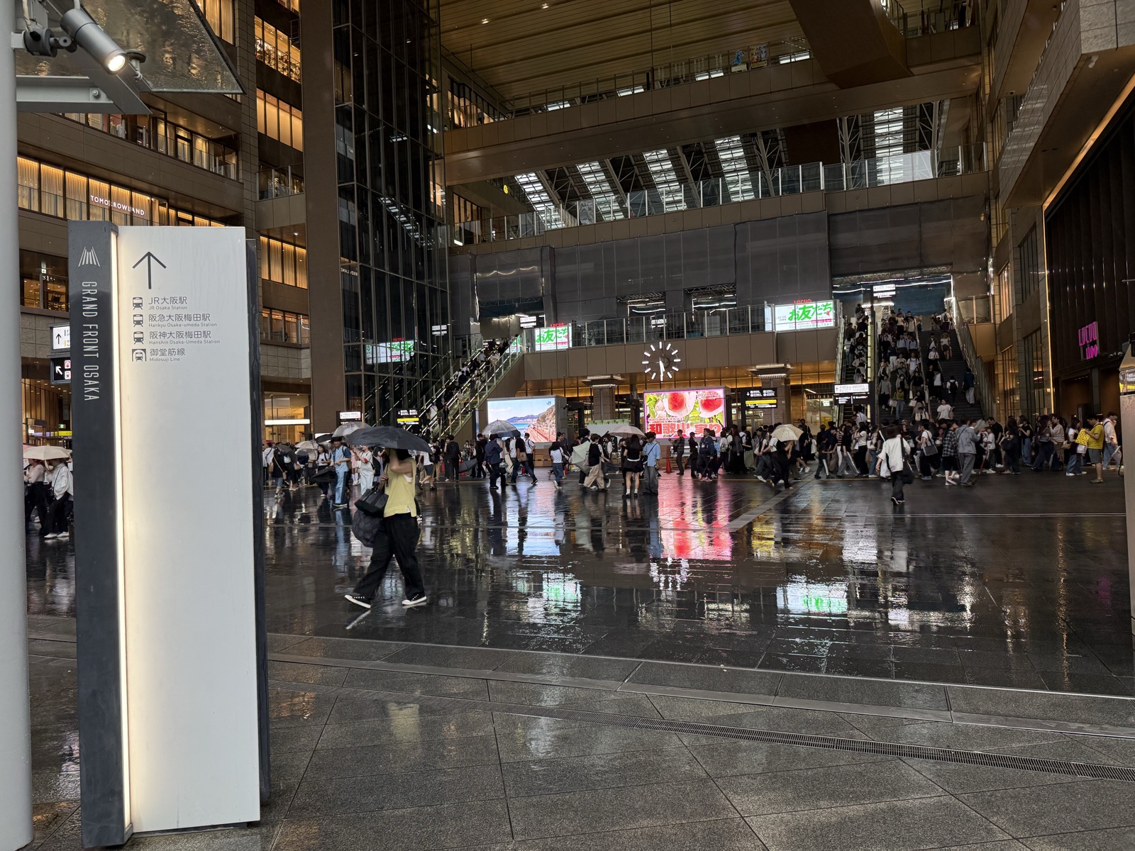 The crowded main concourse and directional signage inside the Osaka Station / Umeda hub — our own photo